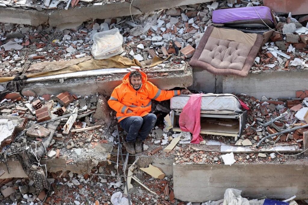 Heartbroken Father Sits Amid Rubble Holding His Dead Daughter's Hand